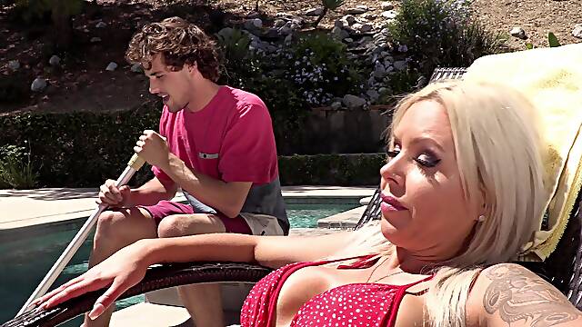 Nina Elle Tempts with Busty Blonde Charm in Poolside Lust