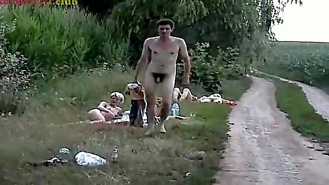 Bulky aged woman is lying on the grass and pushing a large bottle unfathomable in her soaked twat