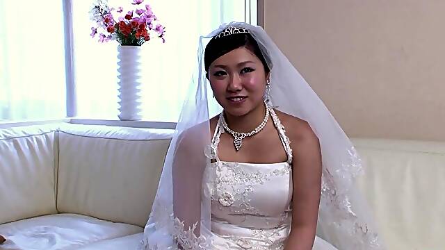 The recent Oriental bride remains attired in her bridal gown through a visitors arrival